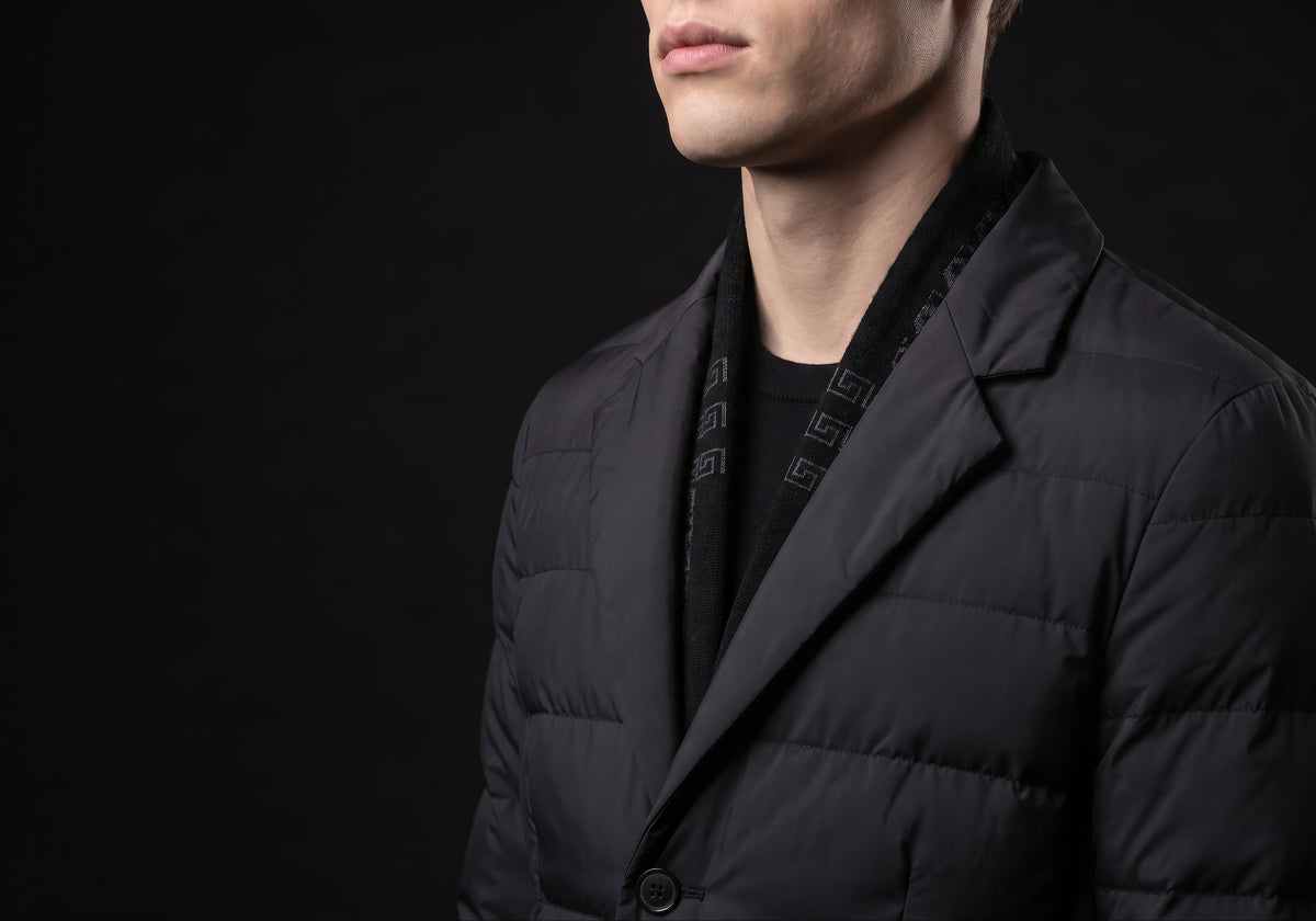 Velmurax men's quilted down coat in black, in a close detail shot on the model