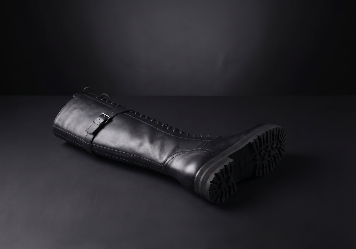 Velmurax women's lace-up knee-high boots in black, showing the outsole and heel