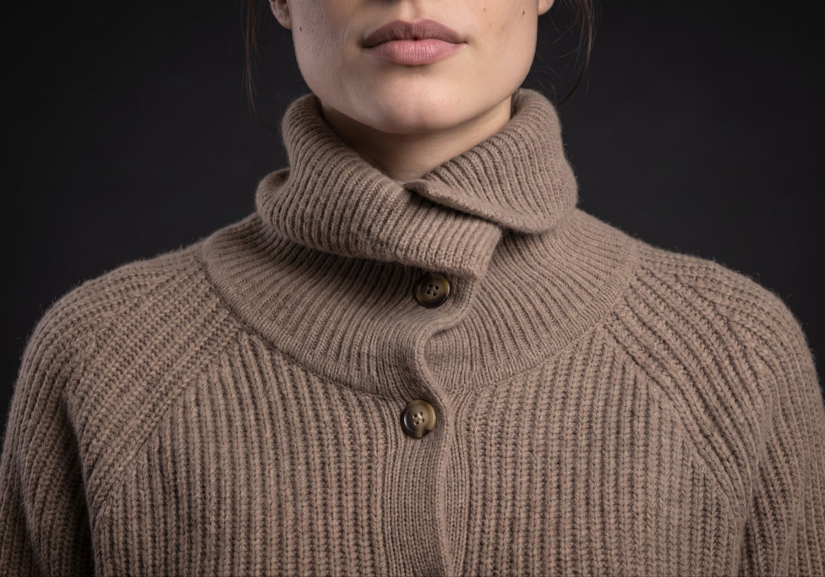 Velmurax turtleneck cardigan collar up close: the folded collar buttoned at its base above the vertical rib knit