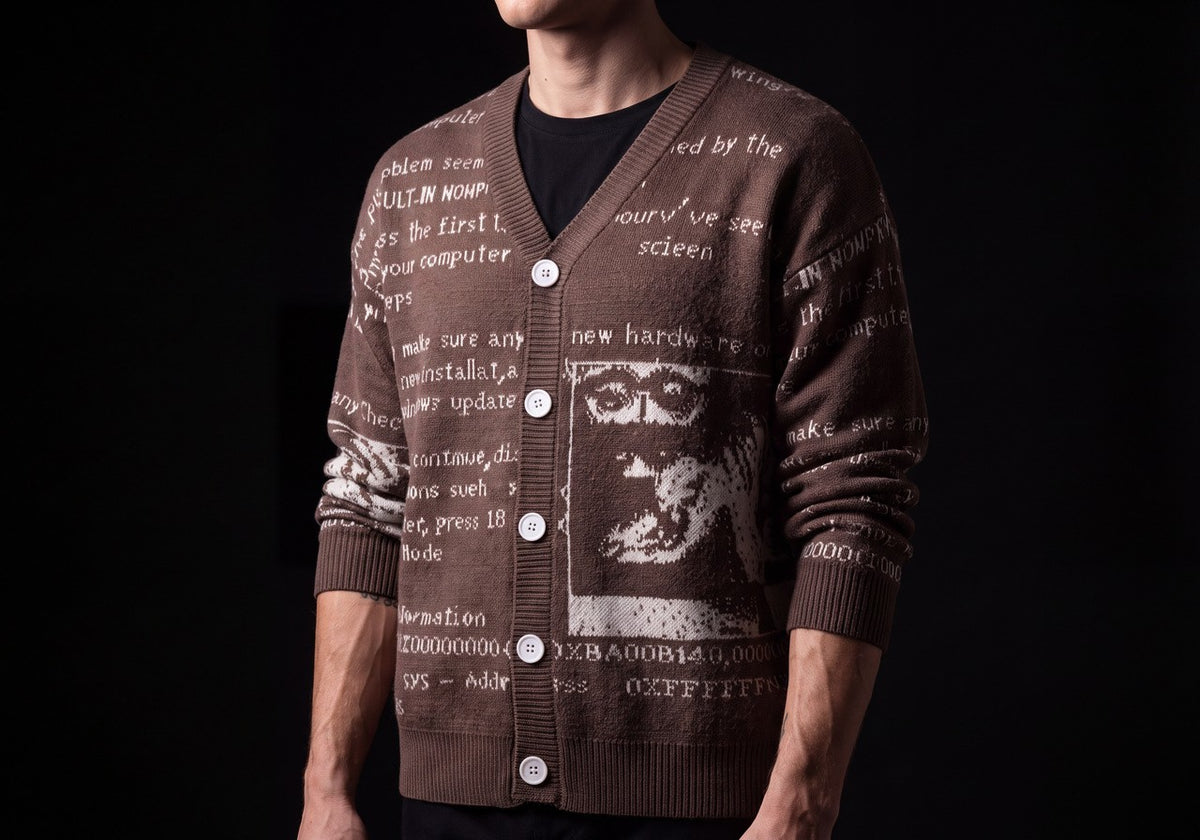 Brown text jacquard cardigan over a black tee, torso view