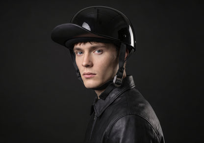 Velmurax baseball cap style helmet in gloss black, worn by a rider, seen in a three-quarter front view on the dark studio set