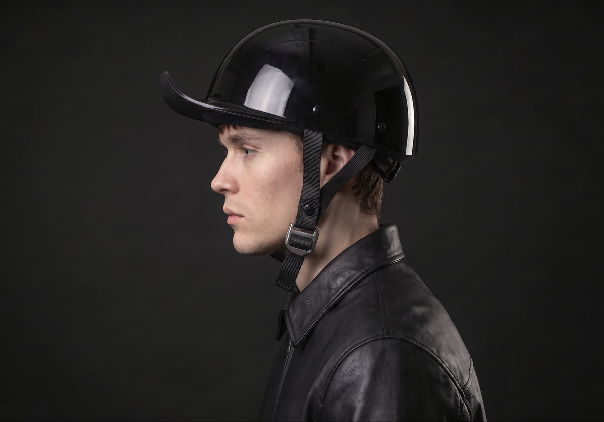 Velmurax baseball cap style helmet in gloss black, in side profile on a rider