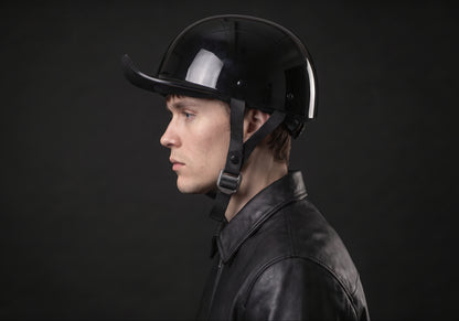 Velmurax baseball cap style helmet in gloss black, in side profile on a rider