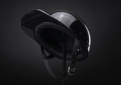 Velmurax baseball cap style helmet in gloss black, tipped back to show the lining and chin strap