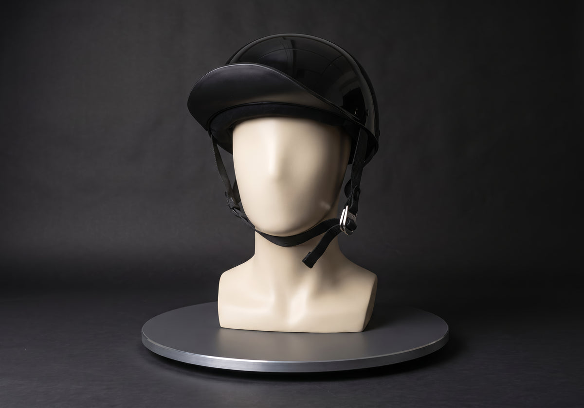 Velmurax baseball cap style helmet in gloss black, on a display mannequin on the studio turntable