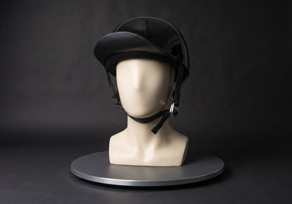 Velmurax baseball cap style helmet in gloss black, on a display mannequin on the studio turntable