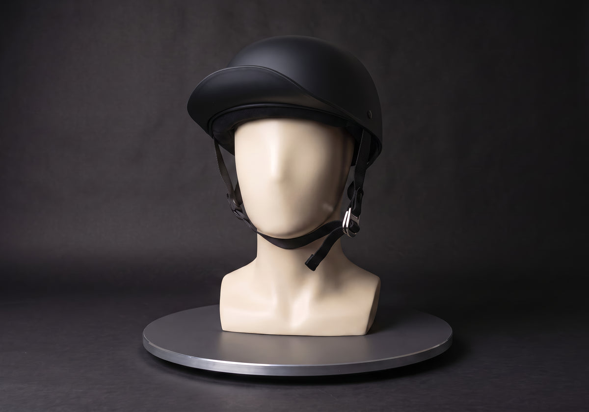Velmurax baseball cap style helmet in matte black, on a display mannequin on the studio turntable
