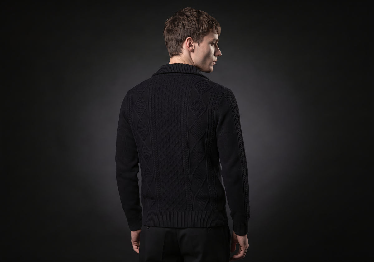 Velmurax cable knit zip cardigan in black, seen from the back on the model, showing the back of the garment