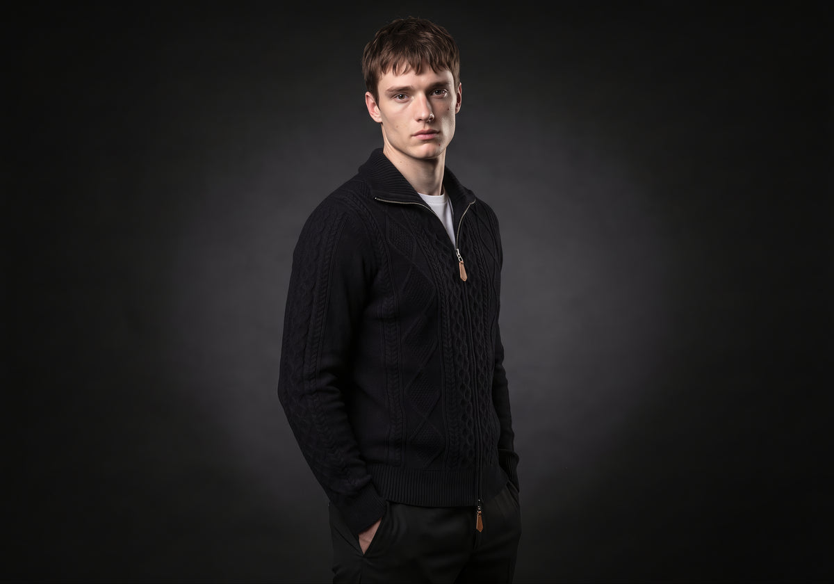 Velmurax cable knit zip cardigan in black, in a three-quarter view on the model on the studio set