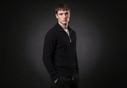 Velmurax cable knit zip cardigan in black, in a three-quarter view on the model on the studio set