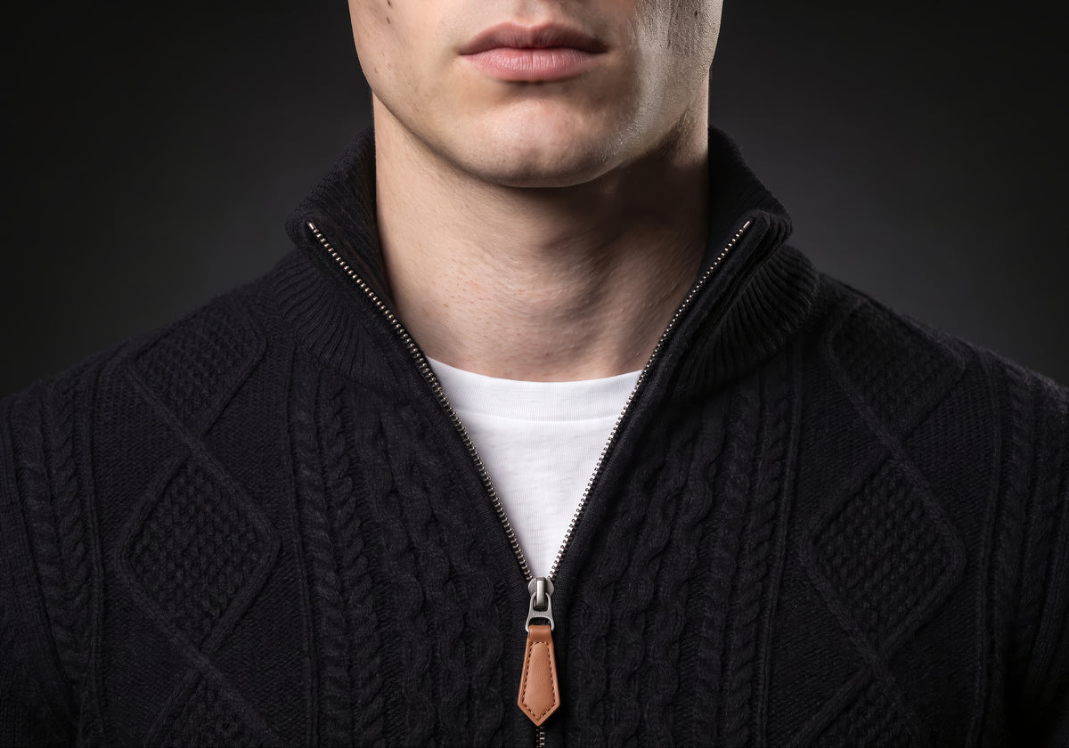 Velmurax cable knit zip cardigan in black, in a close detail shot on the model