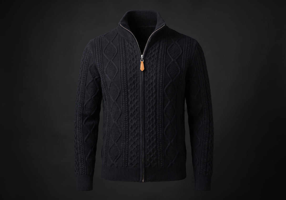 Velmurax cable knit zip cardigan in black, on its own on the dark studio set