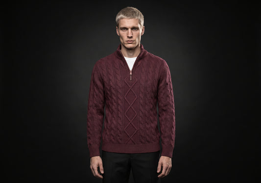 Velmurax cashmere half-zip sweater in burgundy, worn by the model in a front view on the dark studio set