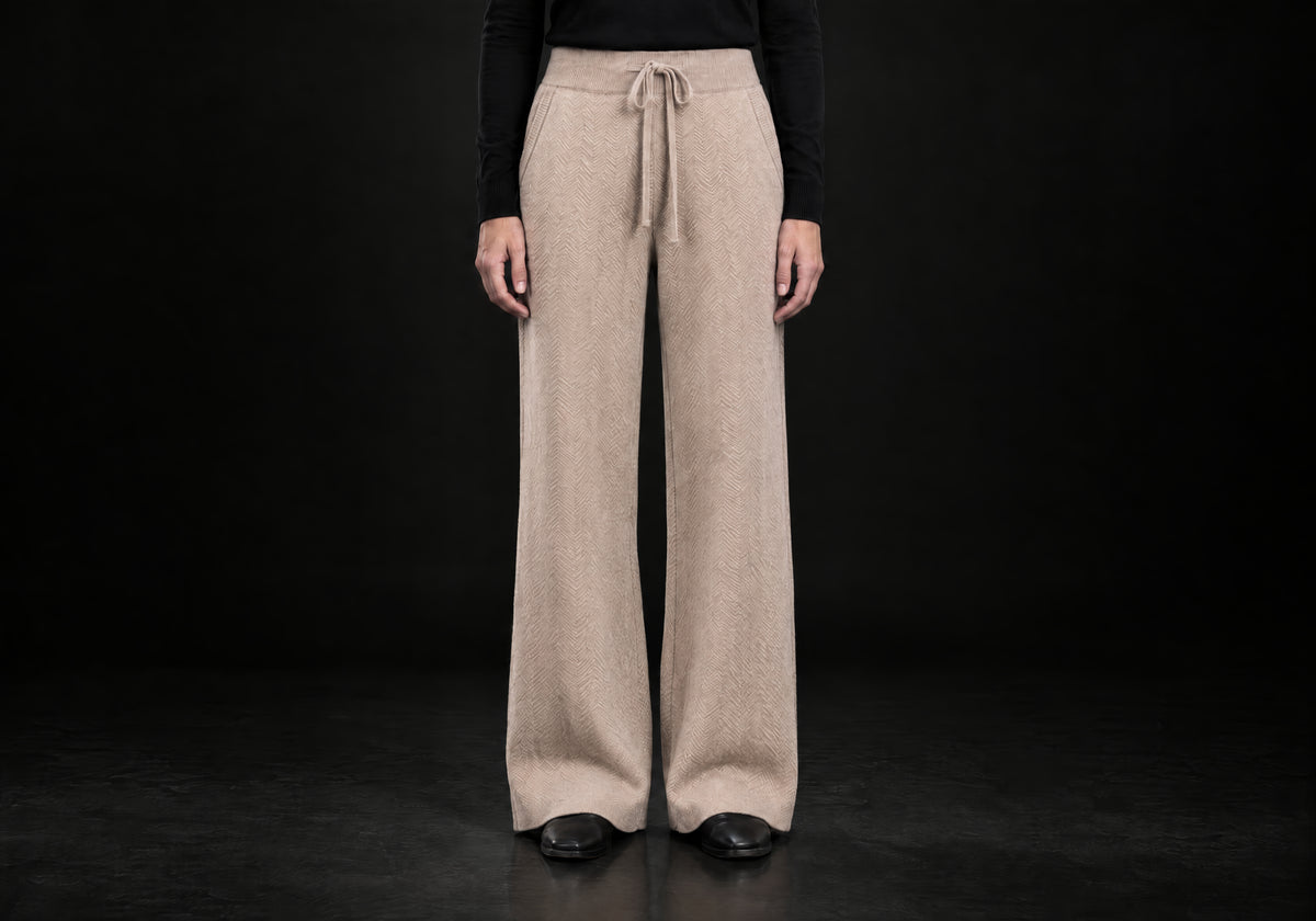 Velmurax Cashmere Wide-Leg Pants in camel with herringbone texture and tied drawstring waist, front view on a model