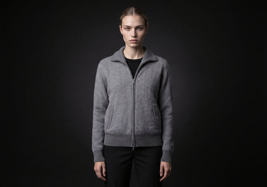 Velmurax cashmere zip cardigan in gray, worn by the model in a front view on the dark studio set
