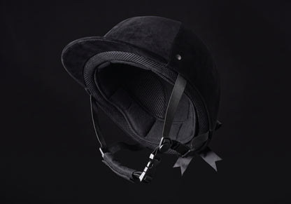 Velmurax classic velvet riding helmet in black velvet, tipped back to show the lining and chin strap
