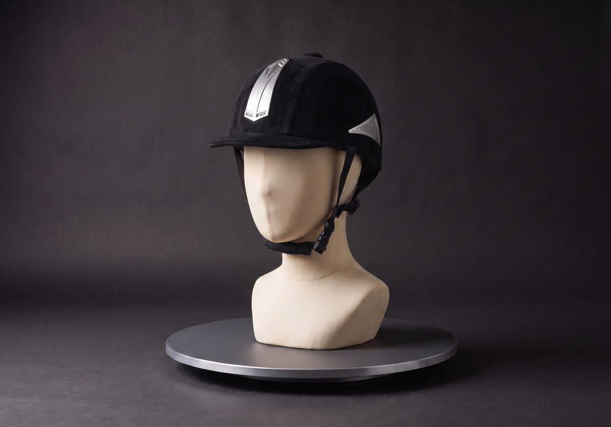 Velmurax classic velvet riding helmet in black, silver stripe, on a display mannequin on the studio turntable