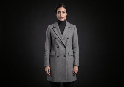Velmurax double-breasted trench coat in gray, worn by the model in a front view on the dark studio set