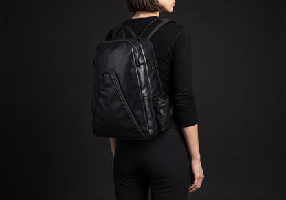 Velmurax equestrian backpack in black, carried on a rider's back with both straps on