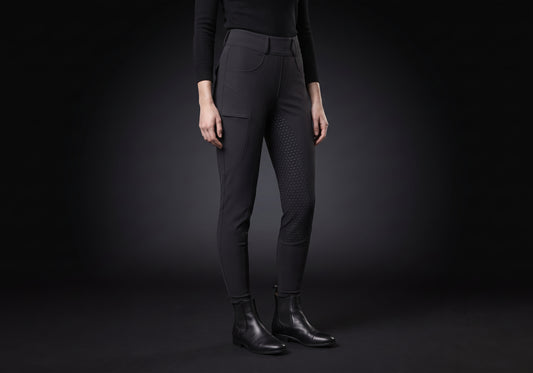Velmurax fleece-lined winter riding pants in black, worn by a rider, seen from the ribcage down on the dark studio set