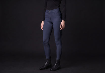 Velmurax full-seat riding breeches in navy, worn by a rider, seen from the ribcage down on the dark studio set
