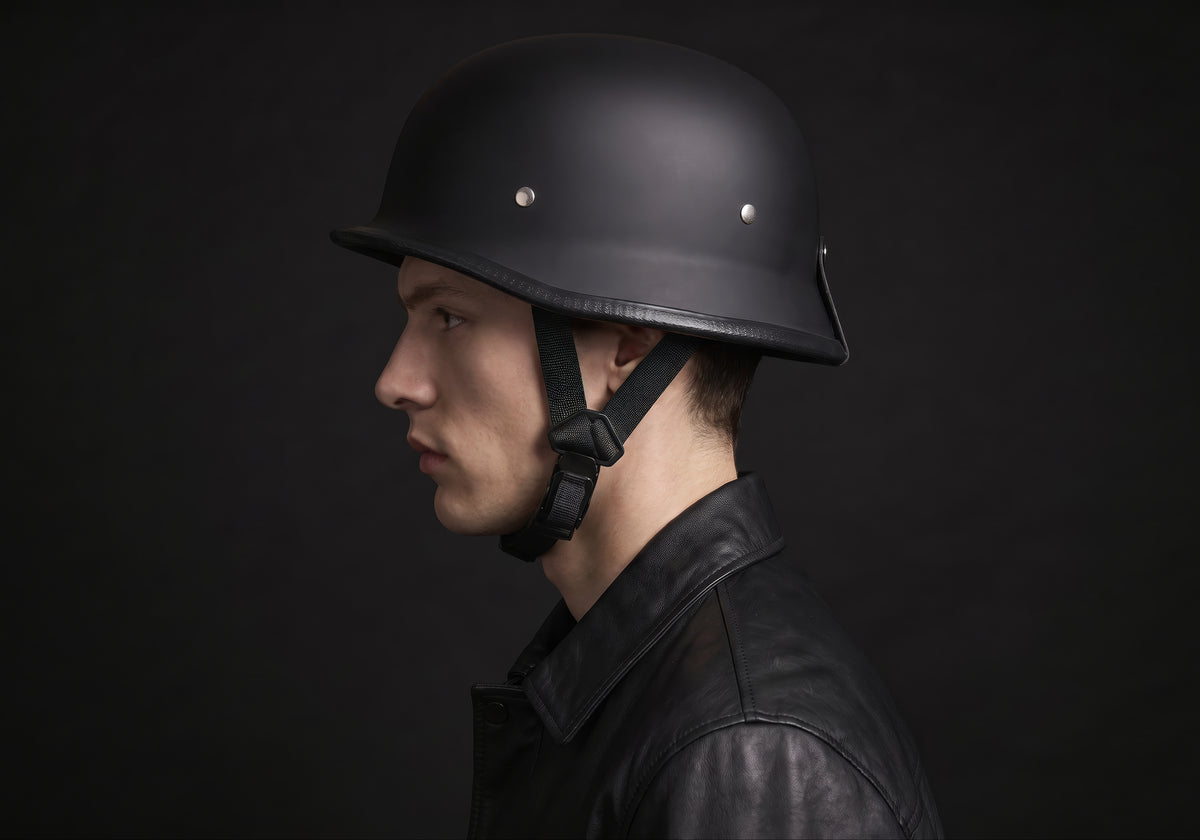Velmurax German-style half helmet in matte black, in side profile on a rider