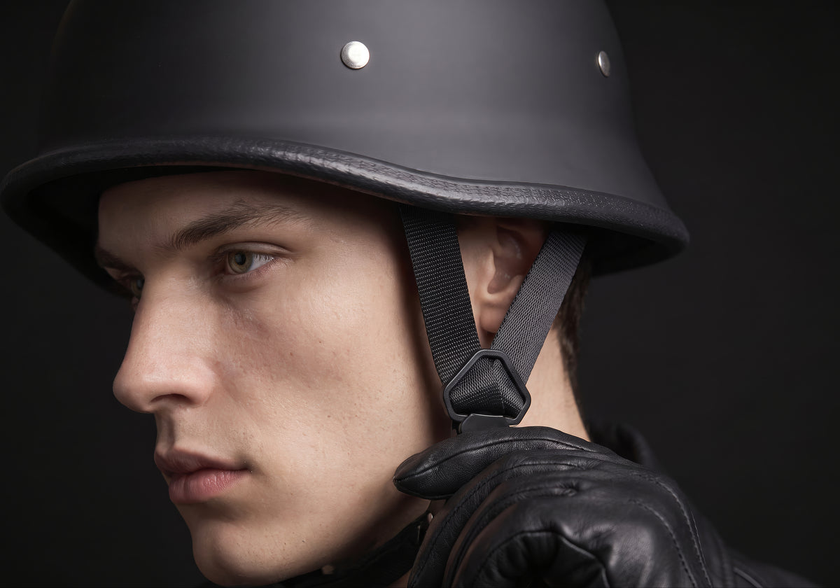 Velmurax German-style half helmet in matte black, in a close detail shot on a rider