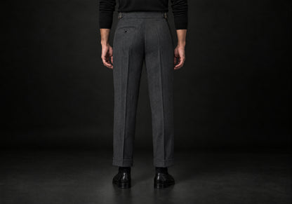 Velmurax Herringbone Wool-Blend Pants in dark gray with a button back pocket and side buckle tabs, back view on a model