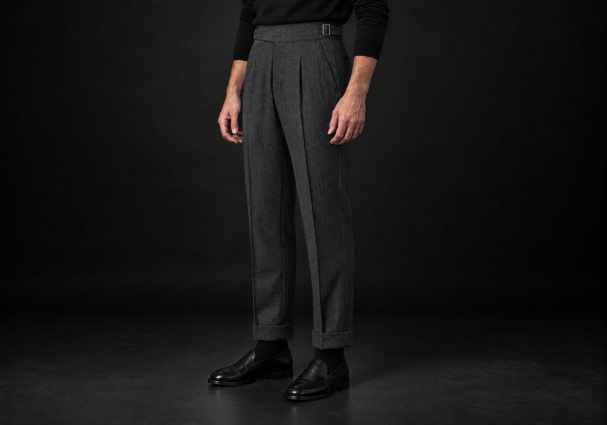 Velmurax Herringbone Wool-Blend Pants in dark gray with cuffed hems and a side buckle tab, three-quarter view on a model