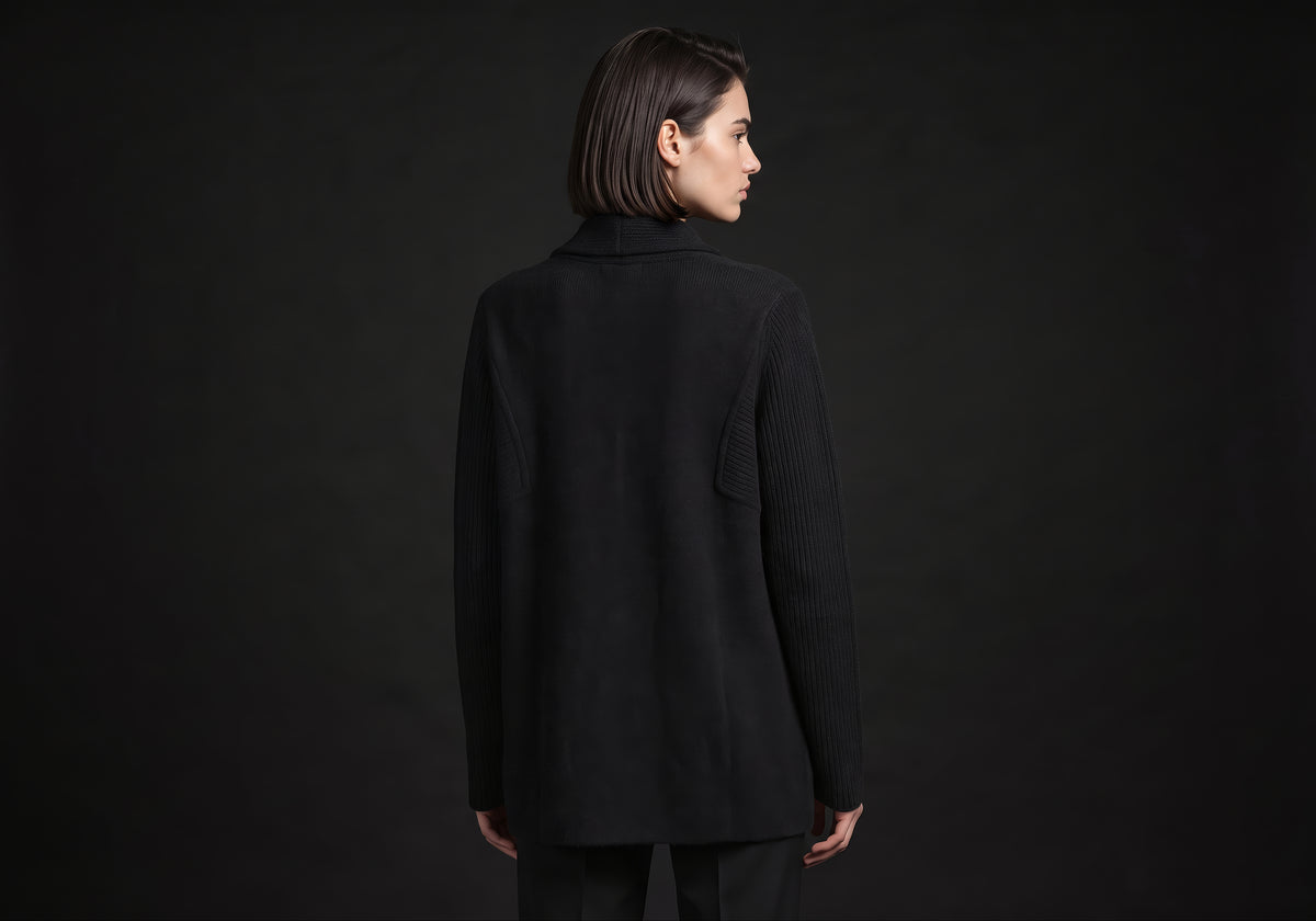 Velmurax knit cashmere coat in black, seen from the back on the model, showing the back of the garment