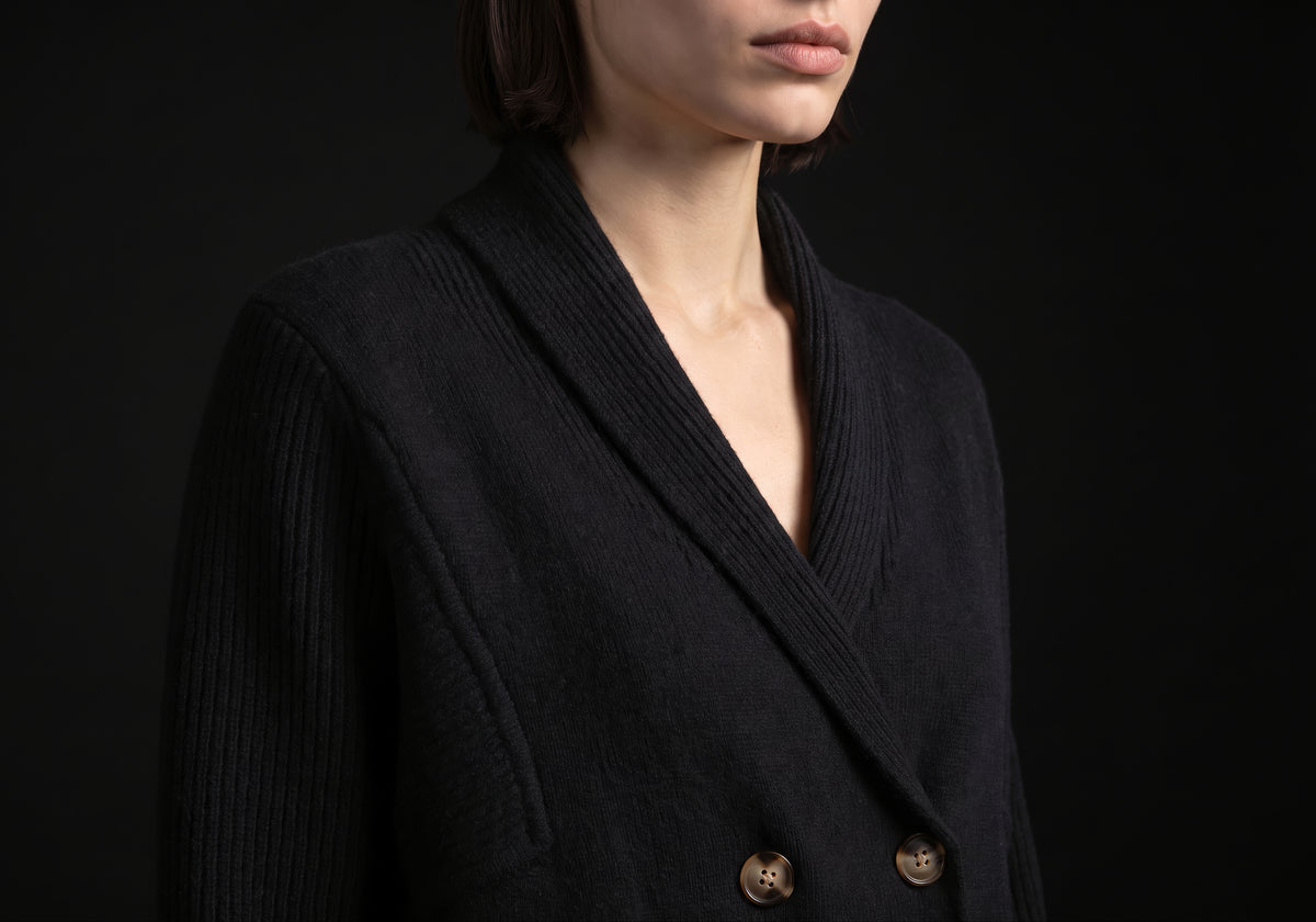 Velmurax knit cashmere coat in black, in a close detail shot on the model