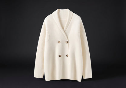 Velmurax knit cashmere coat in milky white, on its own on the dark studio set