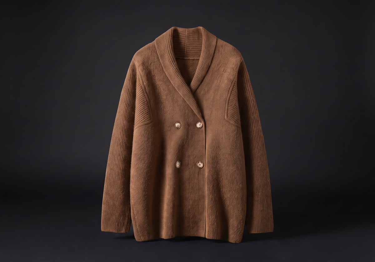 Velmurax knit cashmere coat in camel, on its own on the dark studio set