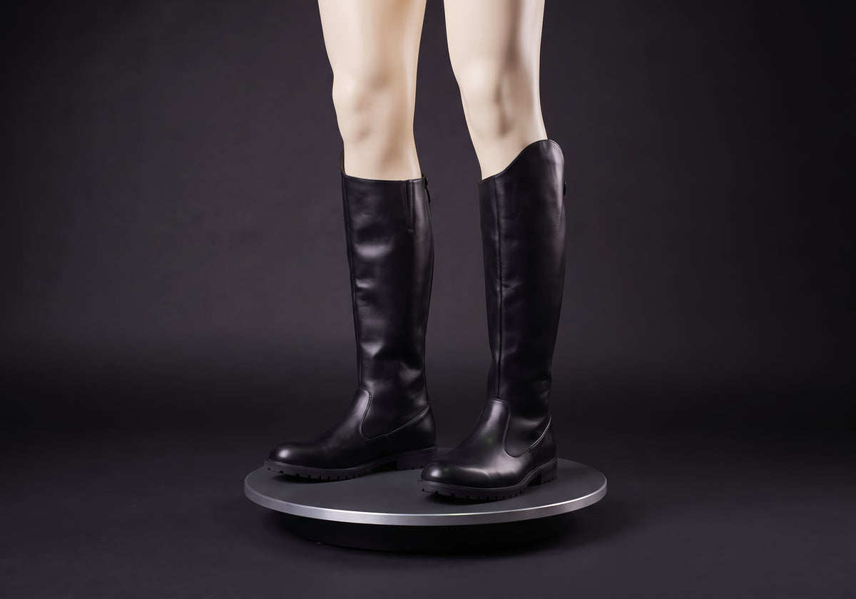 Velmurax men's knee-high riding boots in black, on a display mannequin on the studio turntable