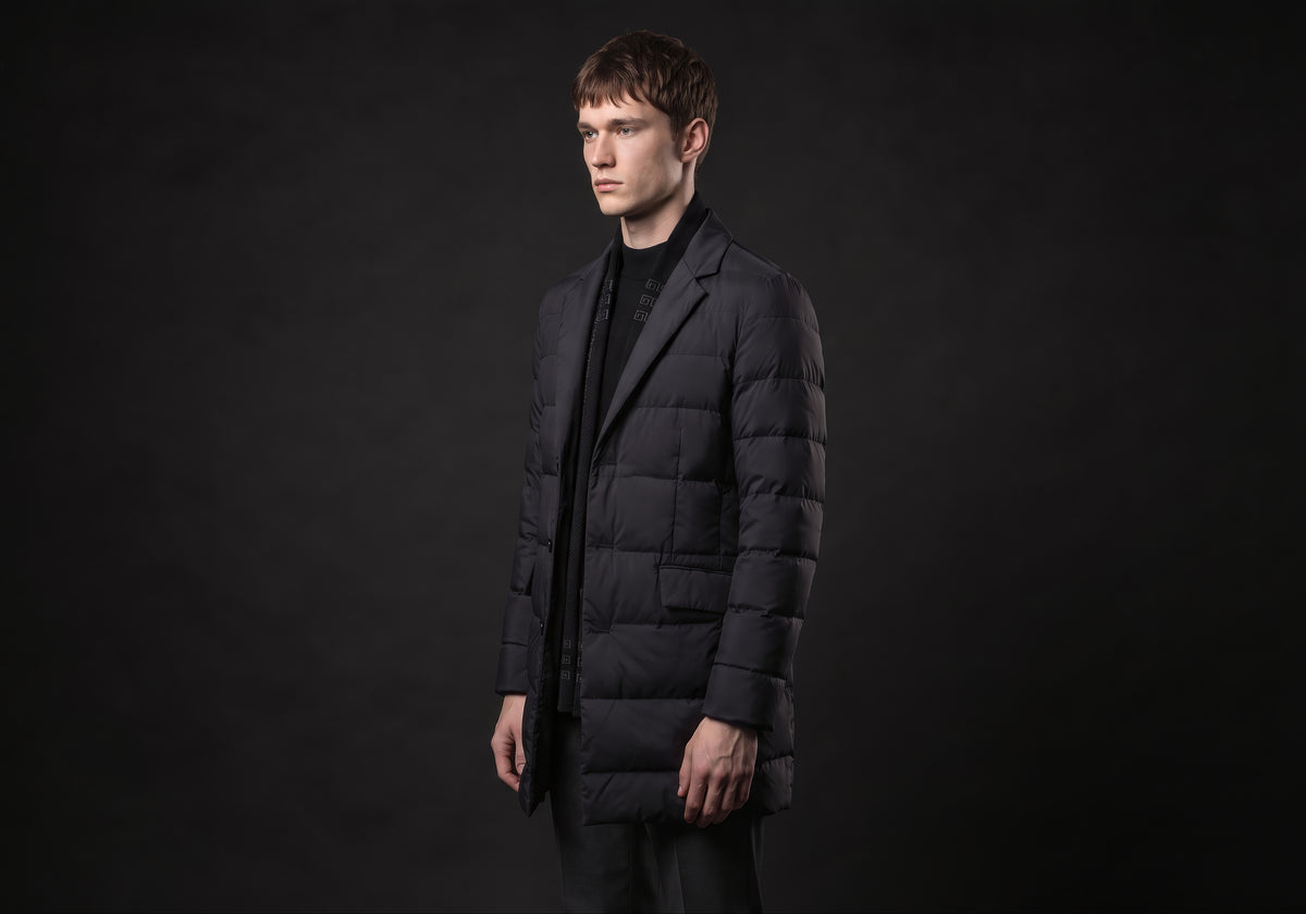 Velmurax men's quilted down coat in black, in a three-quarter view on the model on the studio set