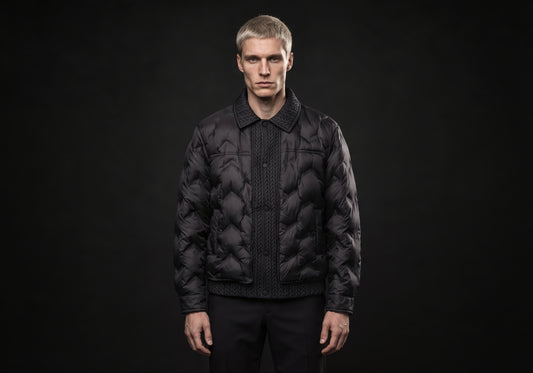 Velmurax men's quilted padded jacket in black, worn by the model in a front view on the dark studio set