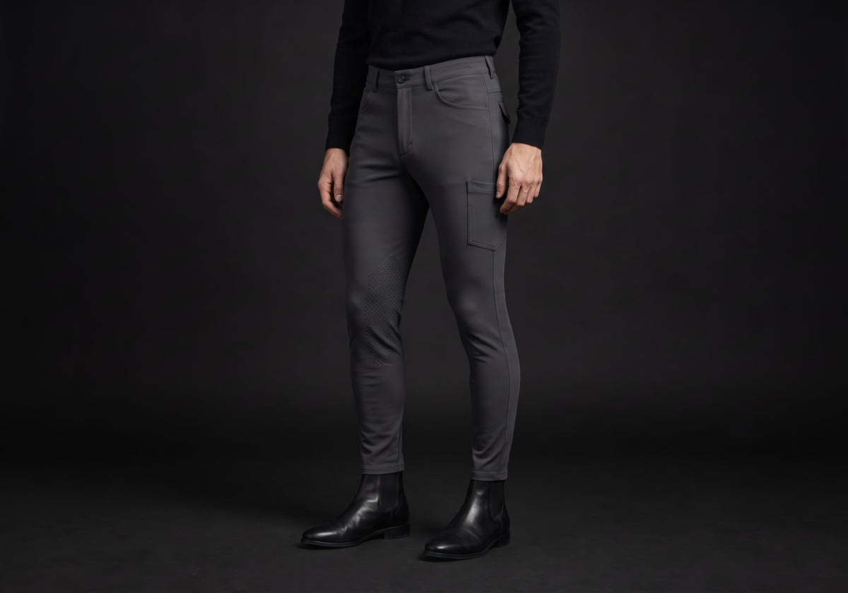 Velmurax men's riding breeches in charcoal, worn by a rider, seen from the ribcage down on the dark studio set