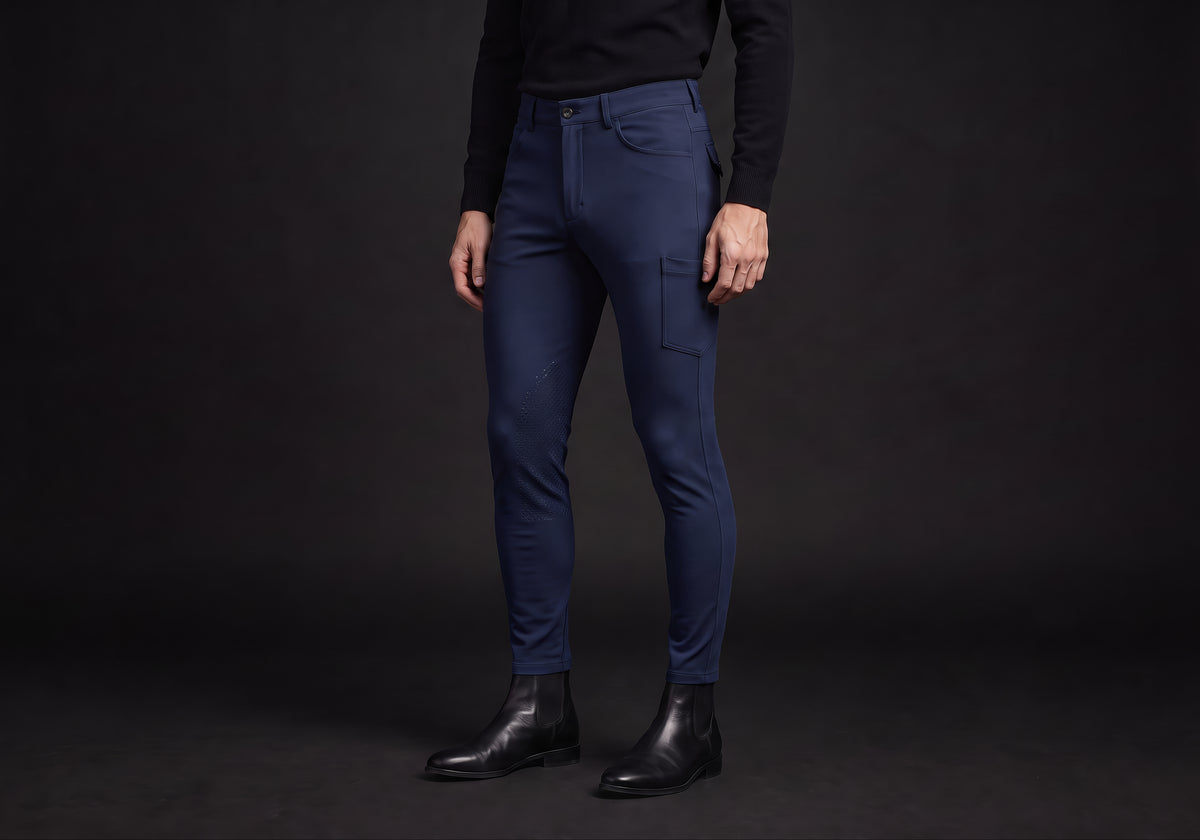 Velmurax men's riding breeches in navy, worn by a rider, seen from the ribcage down on the dark studio set