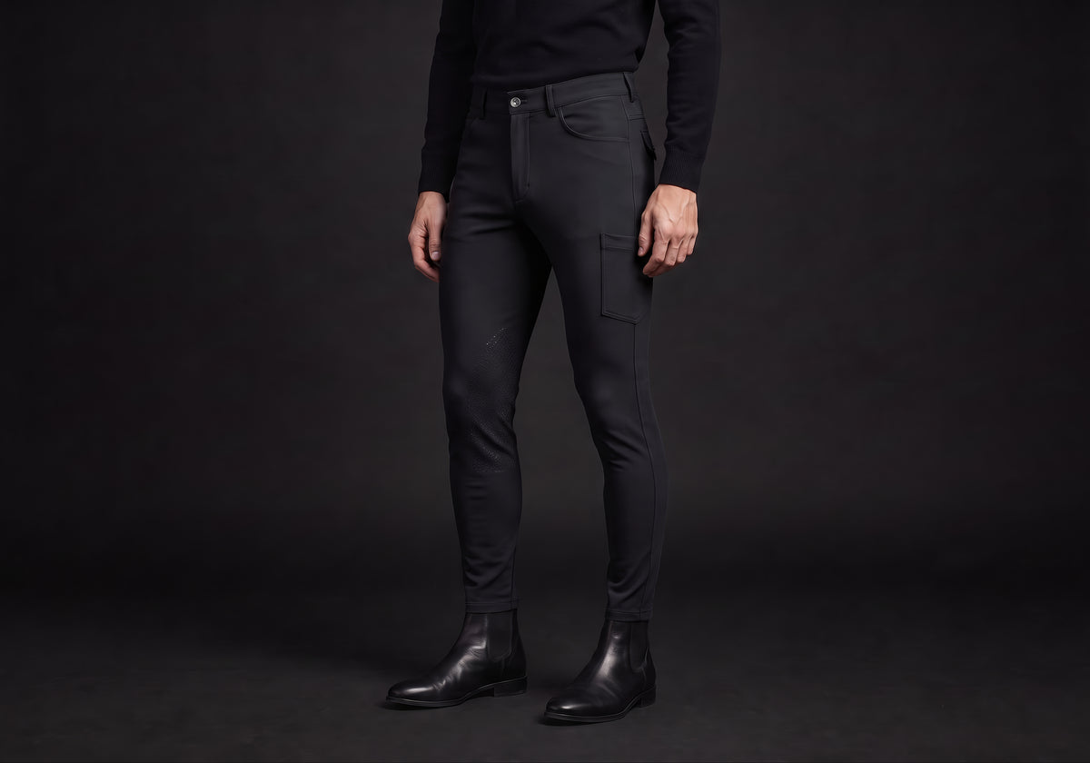 Velmurax men's riding breeches in black, worn by a rider, seen from the ribcage down on the dark studio set