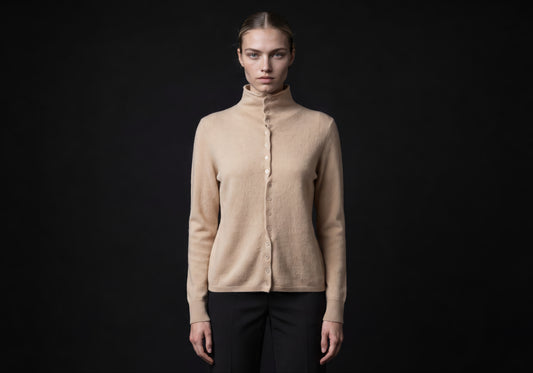 Velmurax mock neck cashmere cardigan in beige, worn by the model in a front view on the dark studio set