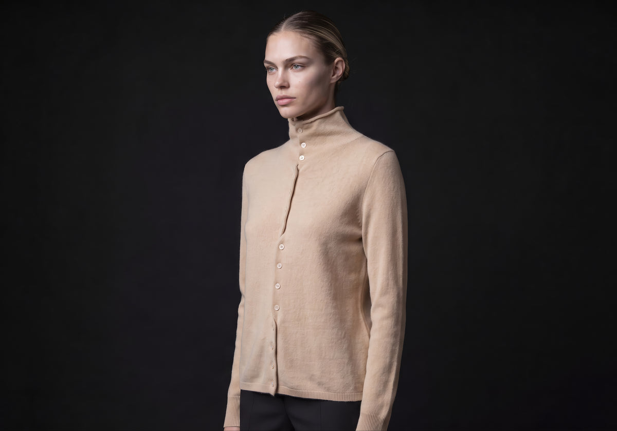 Velmurax mock neck cashmere cardigan in beige, in a three-quarter view on the model on the studio set
