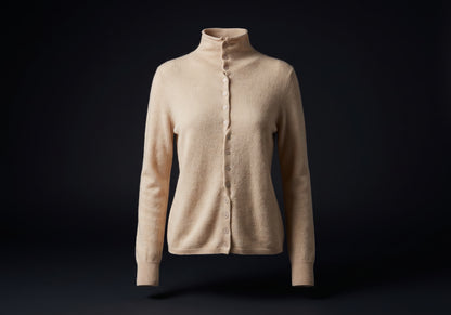 Velmurax mock neck cashmere cardigan in beige, on its own on the dark studio set