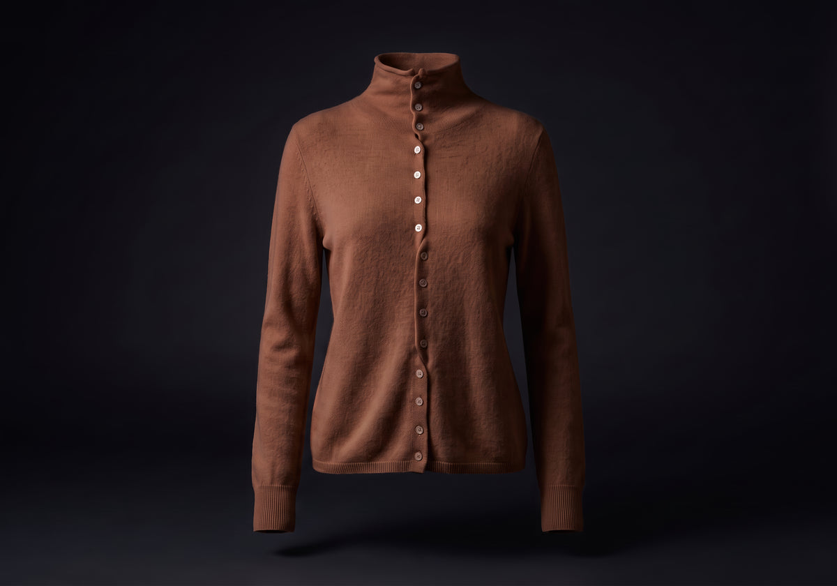 Velmurax mock neck cashmere cardigan in chestnut brown, on its own on the dark studio set