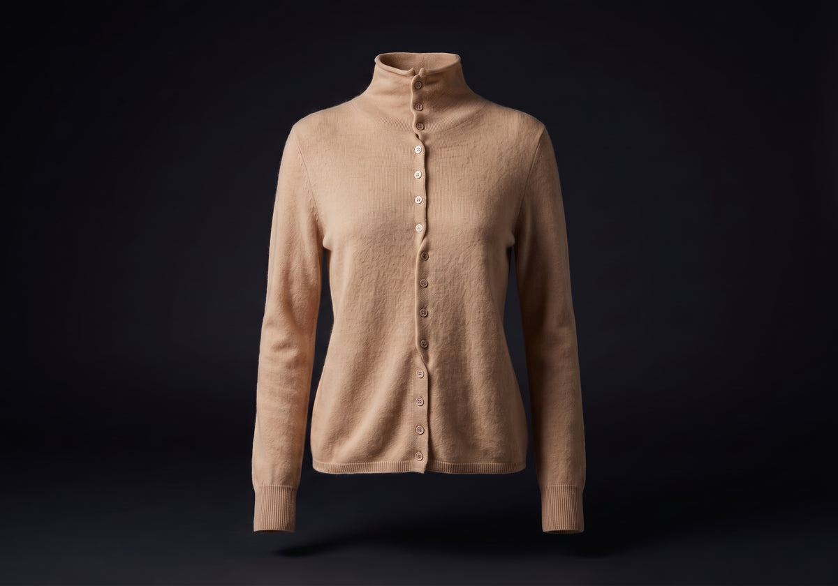 Velmurax mock neck cashmere cardigan in camel, on its own on the dark studio set