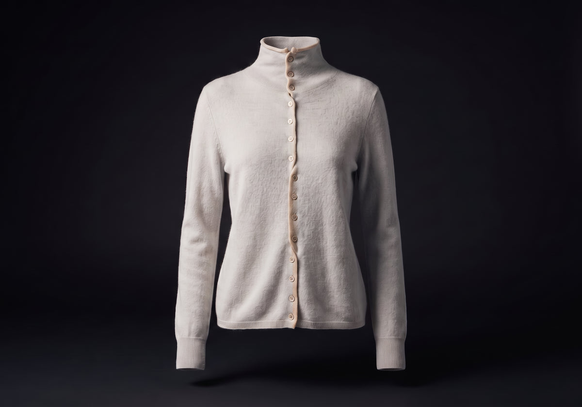 Velmurax mock neck cashmere cardigan in light blue gray, on its own on the dark studio set