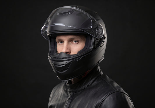 Velmurax modular bluetooth-ready helmet in matte black, worn by a rider, seen in a three-quarter front view on the dark studio set