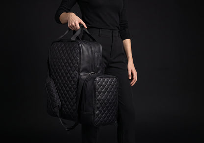 Velmurax quilted boot and helmet bag in black, carried by its two top handles