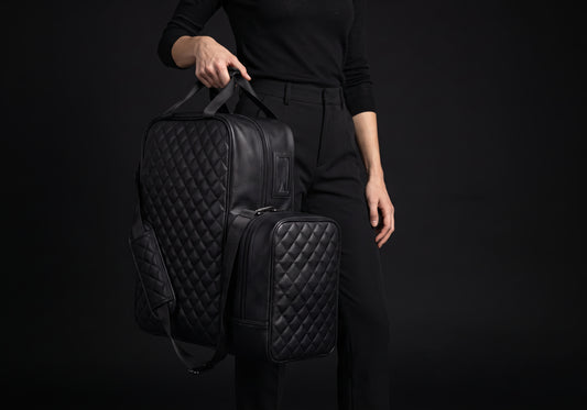 Velmurax quilted boot and helmet bag in black, carried by its two top handles