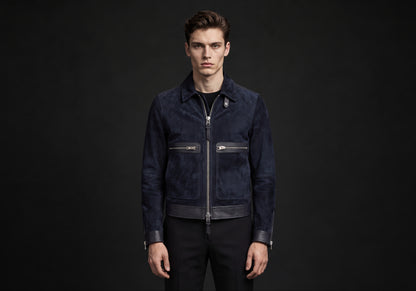 Velmurax short pilot jacket in navy, worn by the model in a front view on the dark studio set