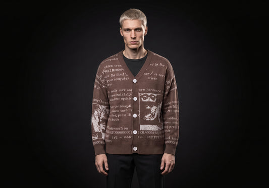 Velmurax text jacquard cardigan in brown, worn by the model in a front view on the dark studio set